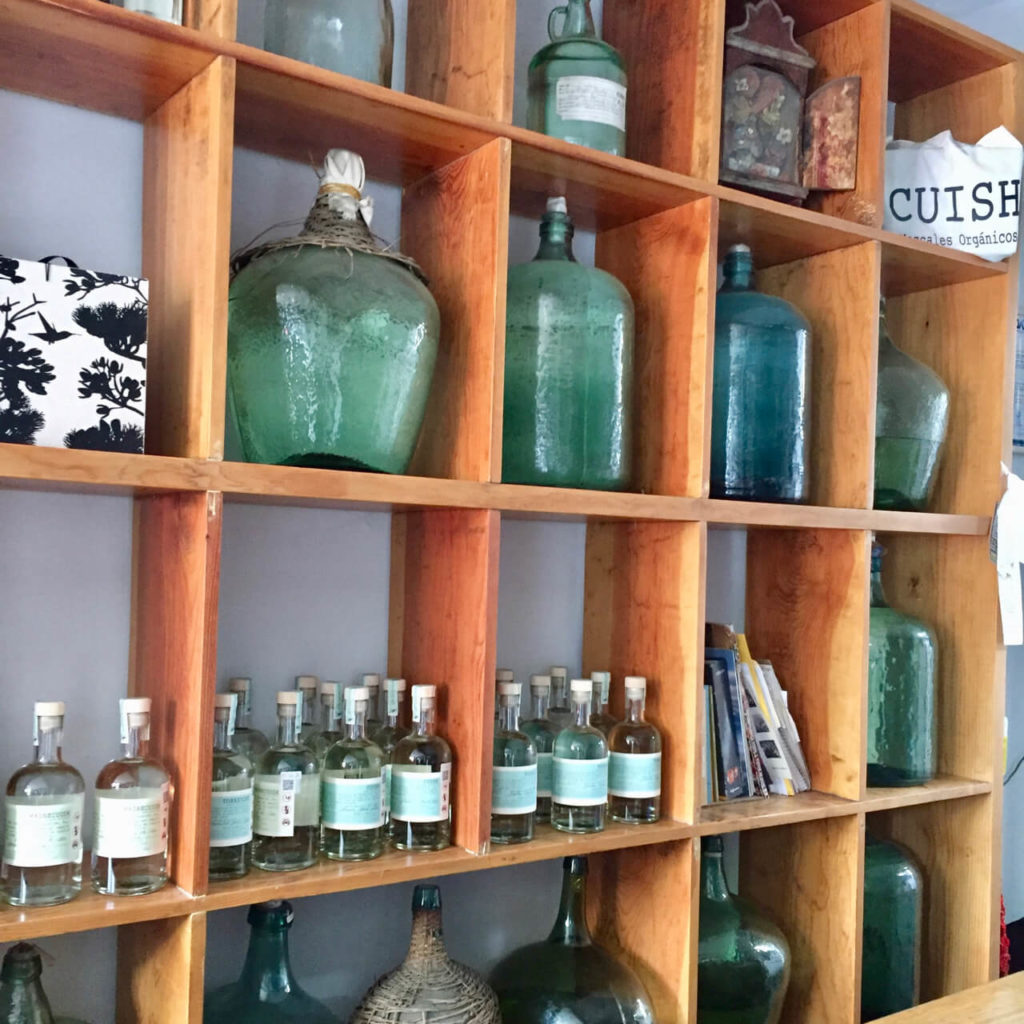 Shelf of bottles at Cuish mezcaleria