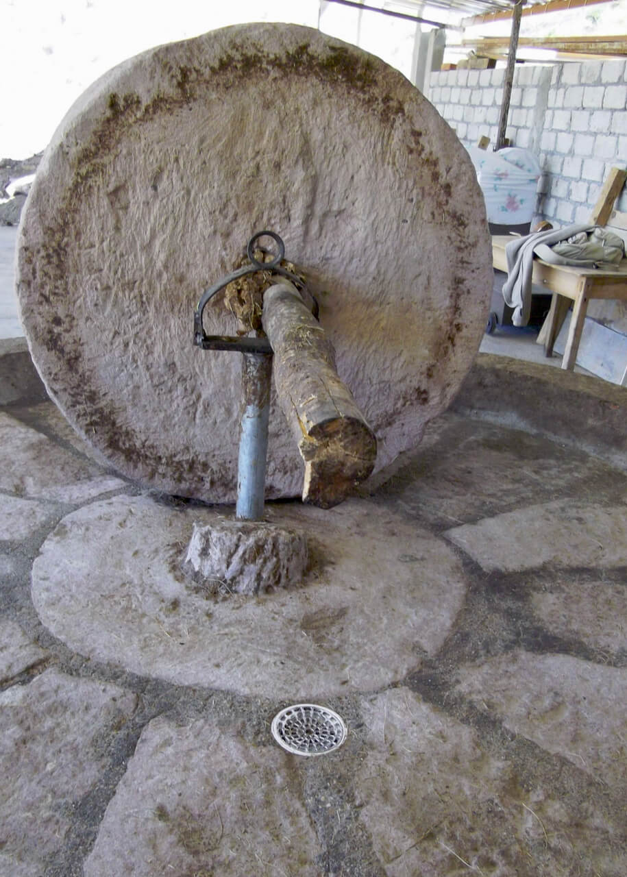 A mezcal tahona crushing area with a drain