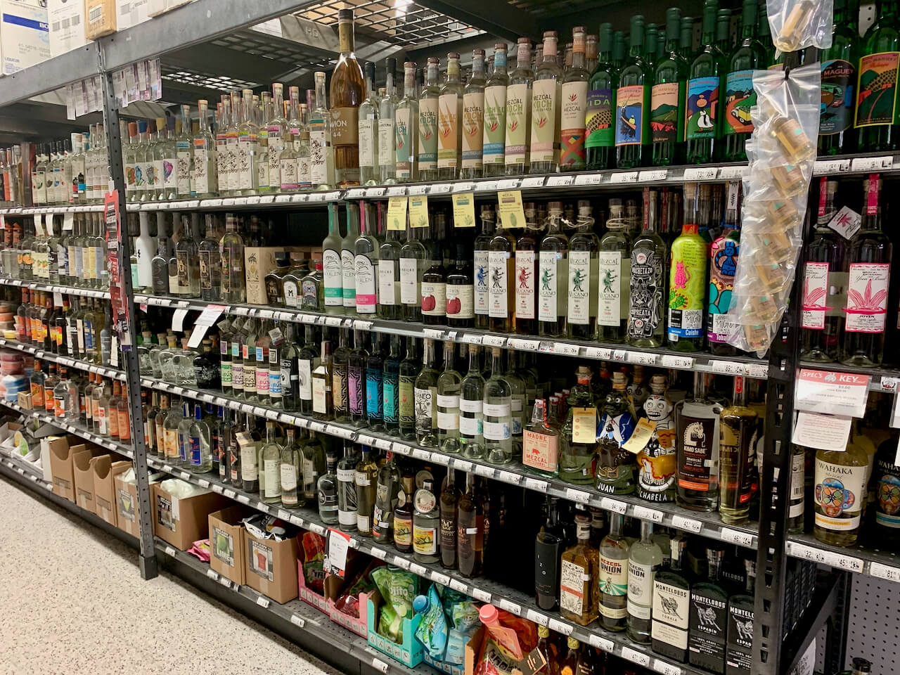 Long row of mezcal bottles at Spec's on Smith Street in Houston