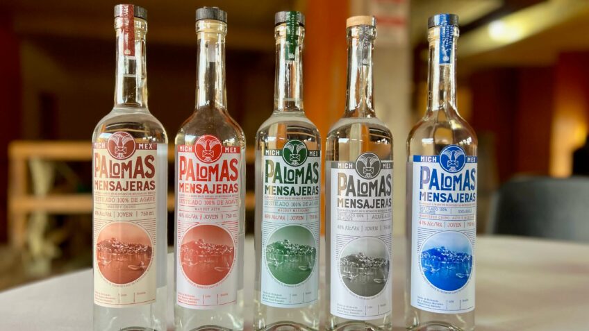 Five glass bottles of different mezcals at the Palomas Mensajeras vinata